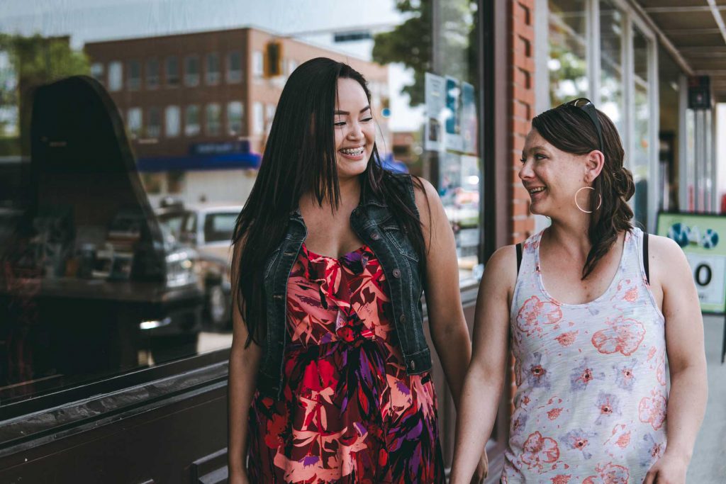 An image of a human service worker and client walking down the street.