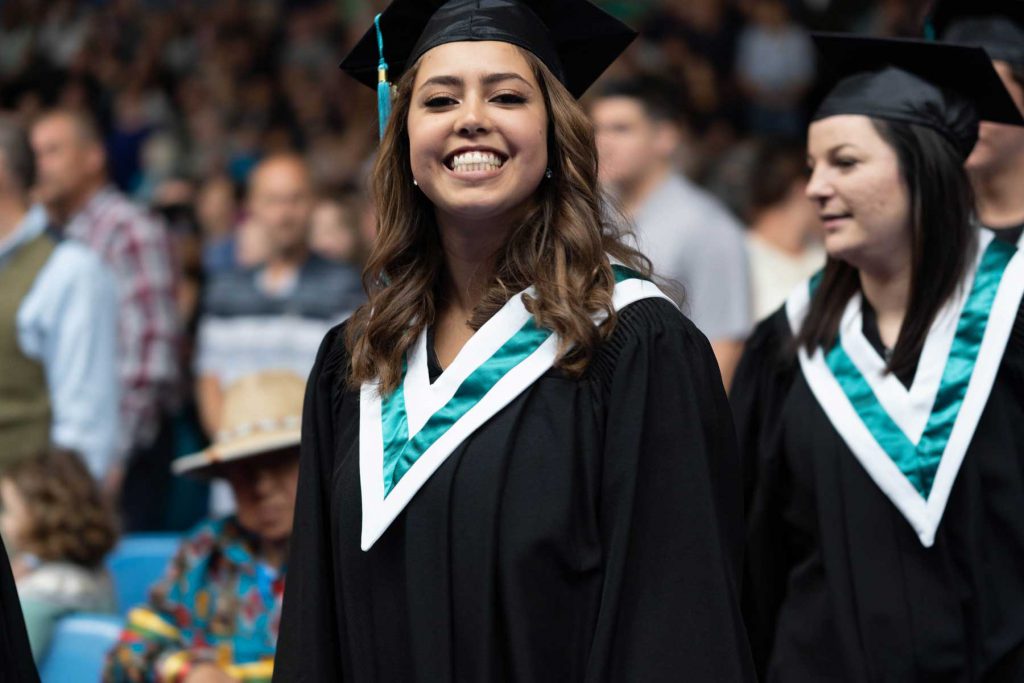 An image of a female student marching in to convocation.
