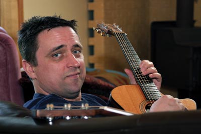 Image of comedian Todd Butler with guitar.