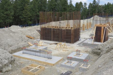 Image of foundation construction including concrete bads and rebar.