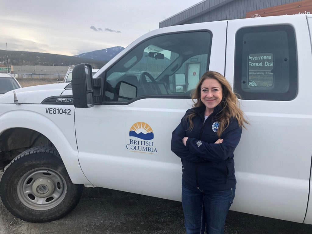 Image of woman standing in front of a Province of BC work truck