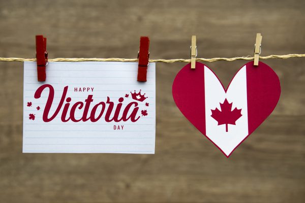 Image shows clothesline with a card reading Happy Victoria Day and a red and white heart with a red maple leaf in the centre pinned to it.