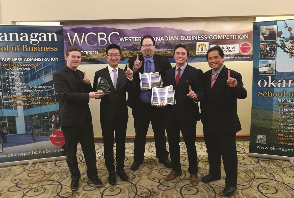 A group of students being presented an award at the Western Canada Business Competition.