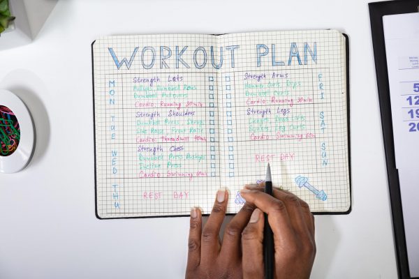Image shows a daily journal with a workout plan written out on it.