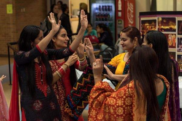 Image of a group of Indian women dancing in traditional Indian clothing.