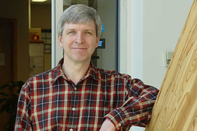 An image of a man standing outside a post-secondary institution.