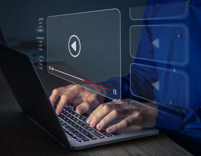 An image of a laptop and with a video prompt icon.