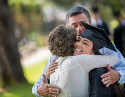 Parents hugging graduate