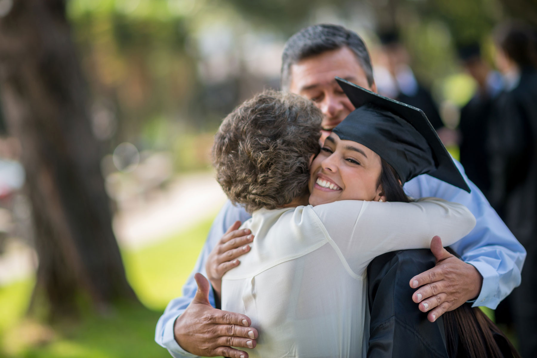 Parents hugging graduate